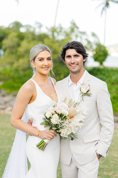 bride and groom looking at the camera during their just married portraits in the whitsundays