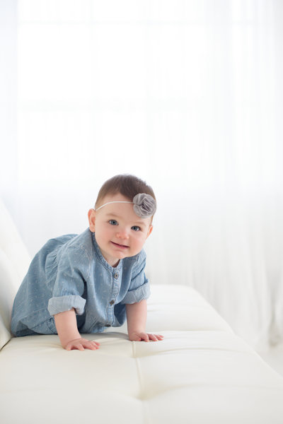 Baby girl crawling in Boise photo studio.