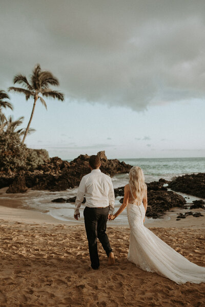 destination wedding photo of bride and groom holding hands during wedding