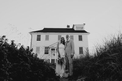 Bride and groom in front of a house in Cape Cod