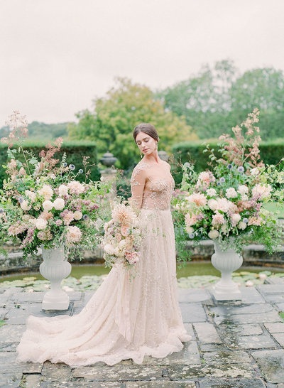 Luxury beaded bridal gown with dramatic floral arrangements for a multi-day destination wedding