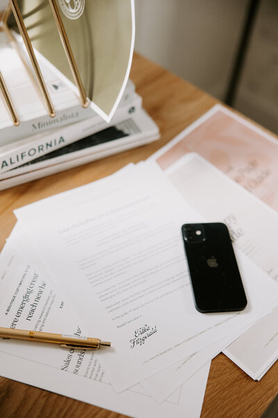 A stack of website copywriting papers on a desk