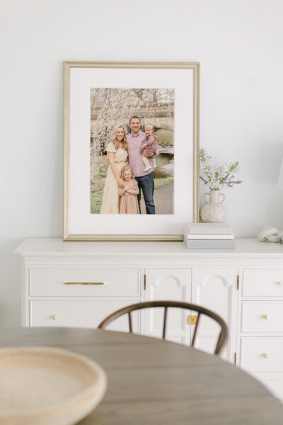 Framed print of a family from a photo session on a table in the living room