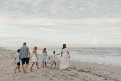 Family of six walking along the beach in the OBX