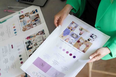 Client brand strategy presentation featuring curated mood board, purple color palette, and visual identity elements laid out for review