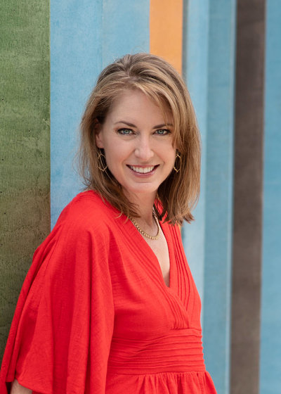 leslie's headshot sitting by wall