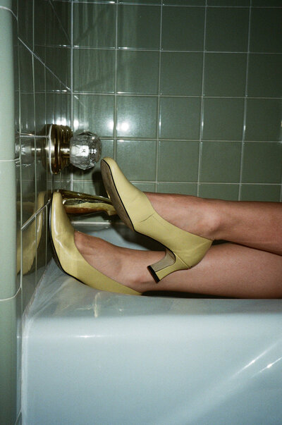 woman's heels in a bath tub