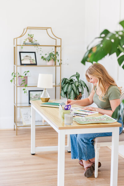 an artist pretending to paint during a brand photography session