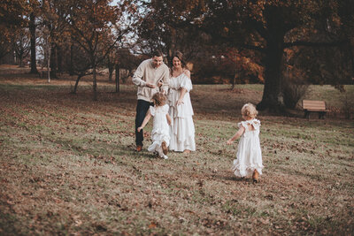 Family Portraits with toddler girls running to Mom and Dad