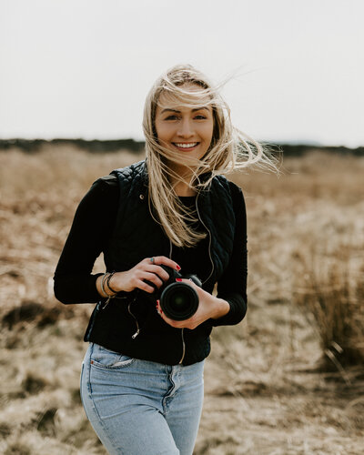 Photographer laughing with camera in hand