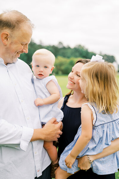 Family with two young kids poses for photo during family session in Raleigh NC