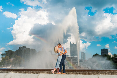 couple celebrating after they got engaged in picture by point state park fountain