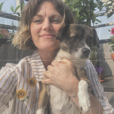 Brooklyn Psychiatric Nurse Practitioner, Laura Temple, smiles for the camera holding her rescue dog, Miso.