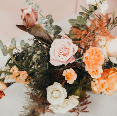 A tied bag of salted caramel popcorn with pretzels and praline pecans