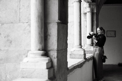 Picture of Los Angeles Wedding Photographer Karin Busch taking photos on a balcony.
