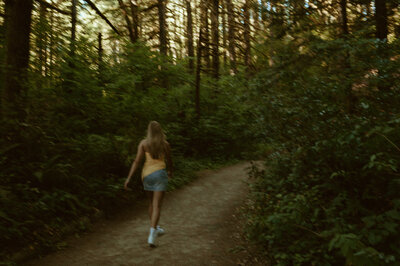 girl walking on trail in washington nature park