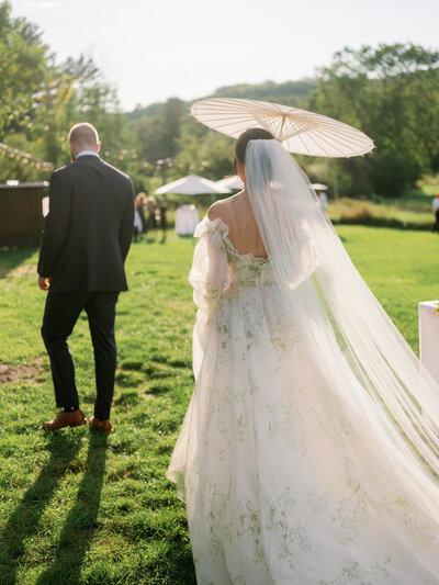 bride walking with umbrella