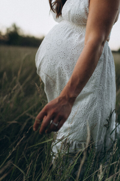 Mom walking through a grass field in Scottsdale