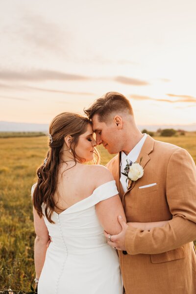 wedding portraits in a field at golden hour