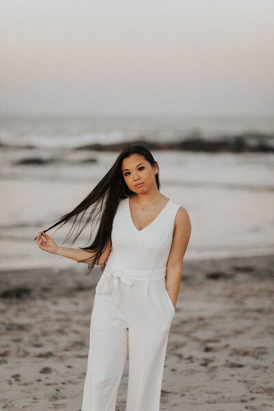 Portrait of female documentary wedding photographer on New Hampshire beach during sunset