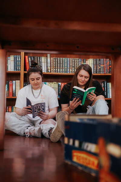 KP and Jessie read books in a bookstore.