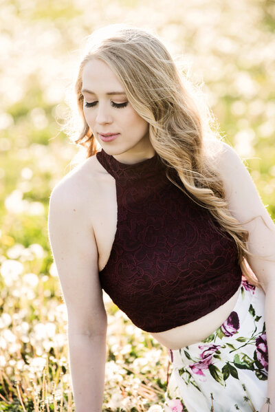 Lakeville Minnesota high school senior photo of girl in a red top in a field of flowers