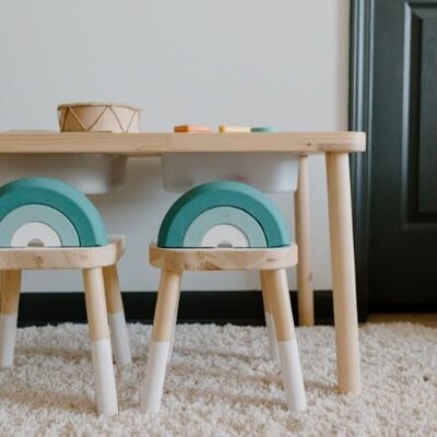 A playtable with 2 stools and wooden toys
