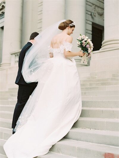 bride-groom-walking-up-steps-immaculate-conception-bonnie-sen-photography
