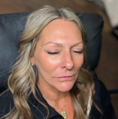 Client with freshly enhanced brows during permanent makeup service at Lavender & Ink Studios