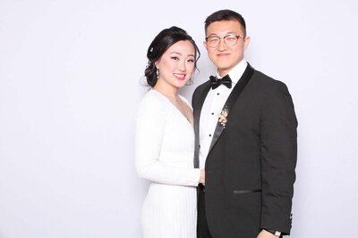 high quality photo of a gorgeous couple posing in front of a white backdrop