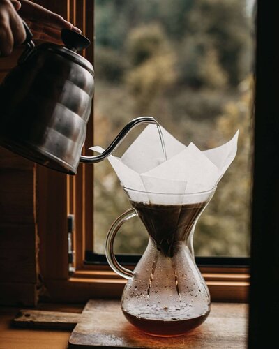 coffee pouring into filter on window
