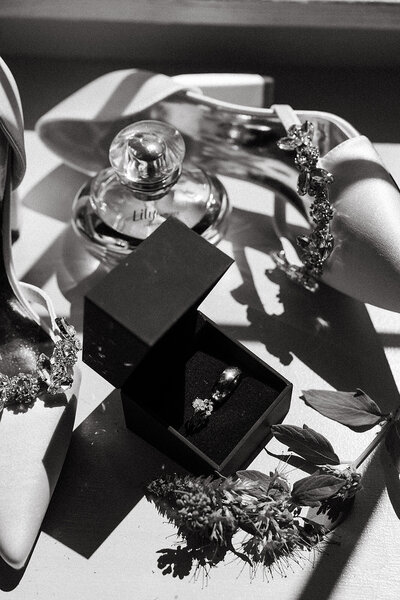 detail shot of brides shoes perfume and jewelry on wedding day in lancaster pa