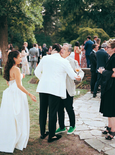 Bride and groom greet guests during cocktail hour at Glen Foerd Estate in Philadelphia, PA