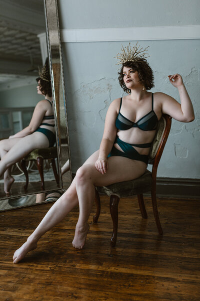 Boudoir photo of a woman lounging in a chair during her boudoir session in Boone, NC,