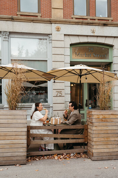 A couple has drinks in Portland, Maine's Old Port after their City Hall Wedding