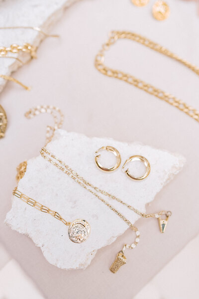 Oahu commercial photographer. Close up product photography of vintage gold necklaces and earrings. Photography by Megan Moura