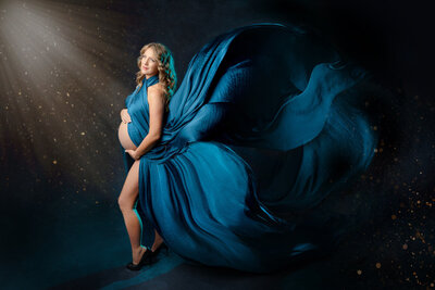 Studio maternity portrait of a beautiful Mom-to-be draped in flowing fabric