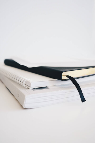 Stack of notebooks on a white background