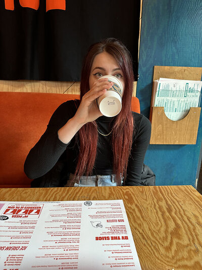 Lifestyle photo of Kami Alicja enjoying a morning coffee, reflecting her creative process and relaxed design style

