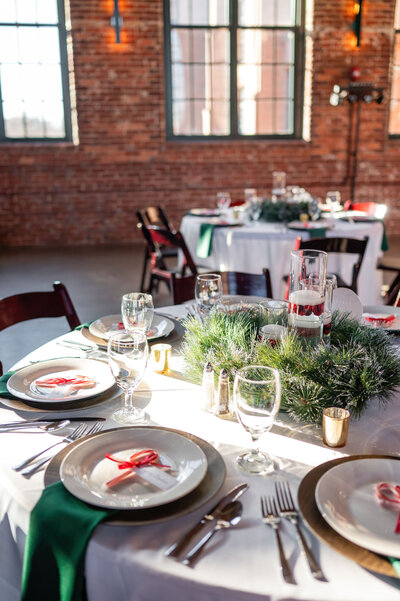 Holiday-themed wedding table with wreath centerpiece and candy canes