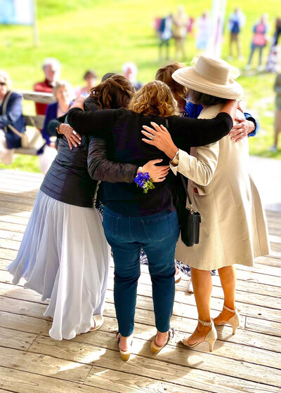 A group of women embrace on the outdoor dance floor at the Camden Snow Bowl in Maine.