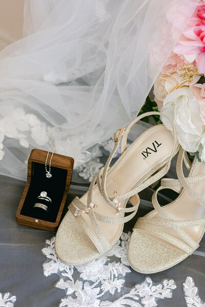 Detail shot of bride's shoes and jewelry and veil