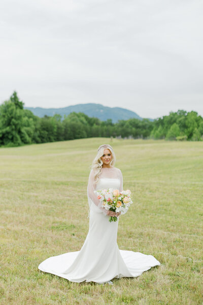 Wedding Ceremony Inspirtation Blush Draped Arbor with Climbing Greenery and Floral Lined Aisle at RiverOaks Charleston