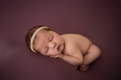 newborn girl, purple backdrop, pearl headband, huntsville texas