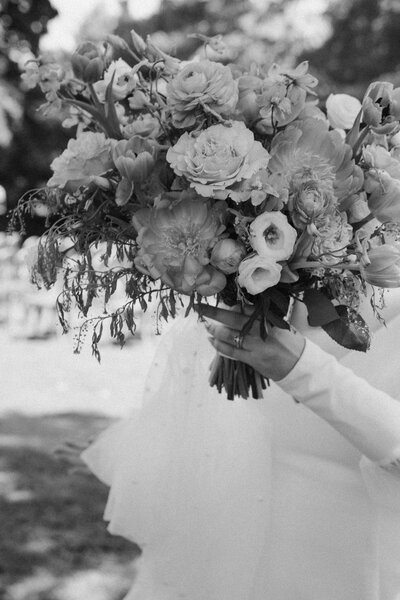 Bride and groom sharing an intimate moment, almost kissing, in a lush New York City garden during their wedding
