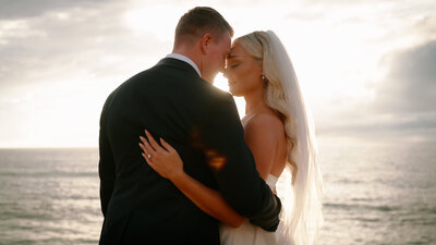 bride and groom kissing at wedding san diego beach