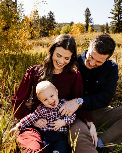 couple smiling with young son