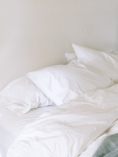 Bed with white linen, the duvet cover turned down