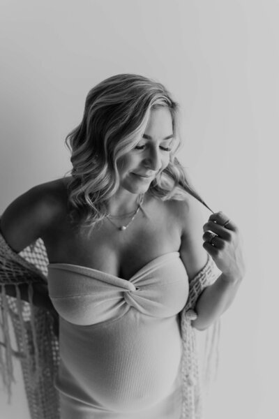 Beautiful blonde woman smiles and plays with her hair