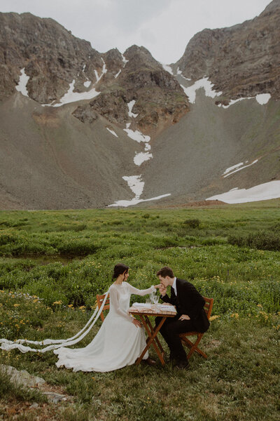 Couple shares a picnic at an alpine lake in Ouray, Colorado